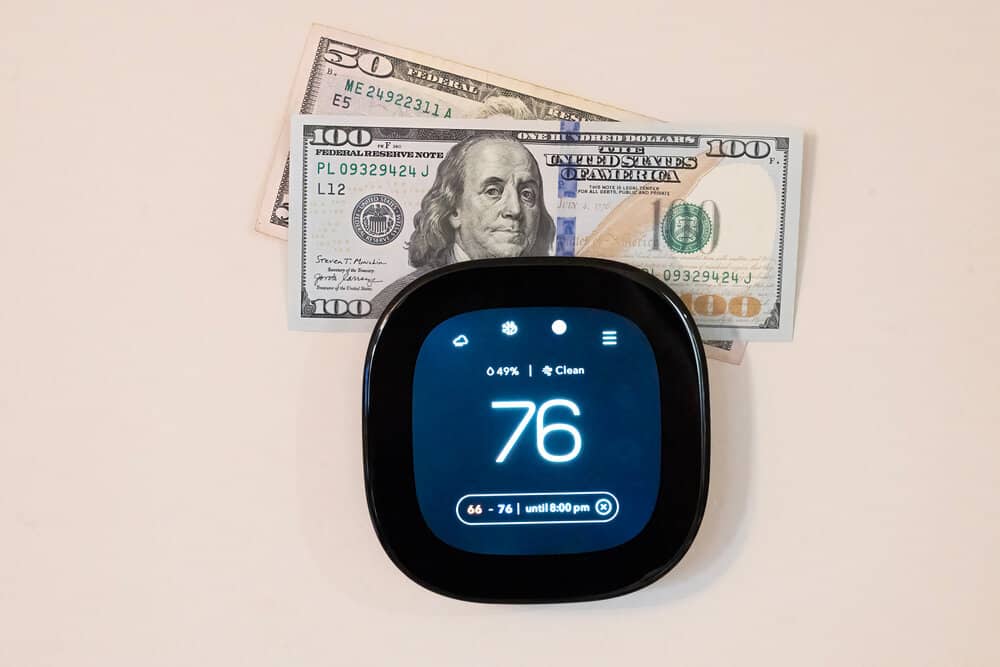 Money on top of digital smart thermostat